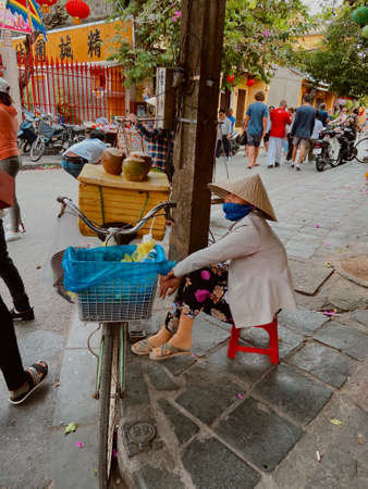 Hoi An, Vietnam - January 24, 2020: Local Vietnamese woman street vendor in market of Hoi An .のeditorial素材