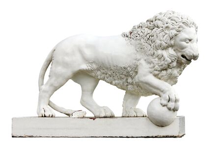 Sculpture of white lion with the paw on the ball. の写真素材