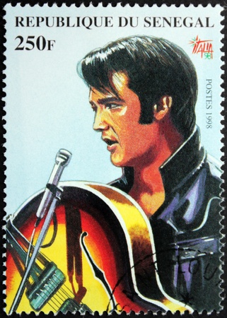 SENEGAL - CIRCA 1998. A postage stamp printed by Senegal shows image portrait of famous American singer Elvis Presley (1935-1977), circa 1998.のeditorial素材