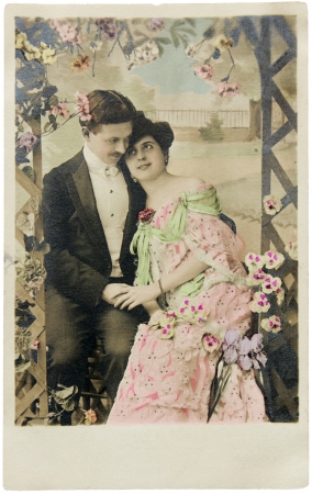 FRANCE - CIRCA 1912. Vintage postcard printed in FRANCE shows hand-tinted photorgaph of man and woman in romantic pose. Circa 1912.のeditorial素材