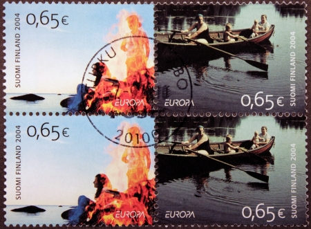 FINLAND - CIRCA 2004: A set of four stamps printed by FINLAND shows idyllic scenes of Finnish life and beautiful landscapes, circa 2004. のeditorial素材