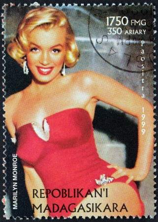 MADAGASCAR - CIRCA 1999: A postage stamp printed by MADAGASCAR shows image portrait of famous American actress, model and singer Marilyn Monroe (1926-1962), circa 1999のeditorial素材