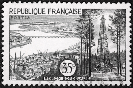 FRANCE - CIRCA 1955: A stamp printed by FRANCE shows view of Bordeaux, Gironde Department, France - The Garonne river, the bridges, and the spires of the Cathedral, circa 1955.のeditorial素材