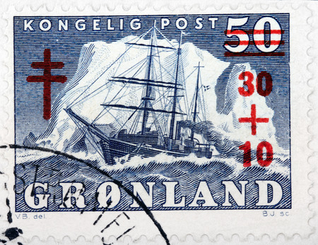 GREENLAND - CIRCA 1950: A stamp printed by DENMARK shows The Arctic Vessel Gustav Holm against iceberg, circa 1950のeditorial素材