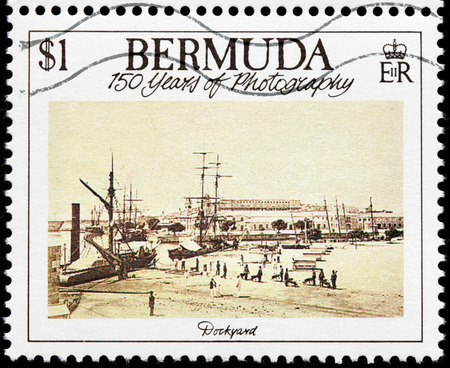 BERMUDA - CIRCA 1989: A stamp printed by GREAT BRITAIN shows old photograph of Bermuda Dockyard, circa 1989のeditorial素材