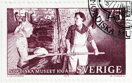 SWEDEN - CIRCA 1973: A stamp printed by SWEDEN shows Baking Bread in the old manner at Utbunge, Gotland, circa 1973のeditorial素材