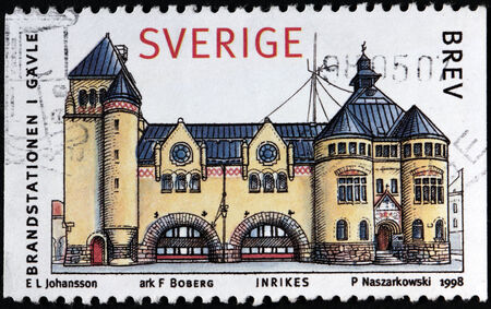 SWEDEN - CIRCA 1998: A stamp printed by SWEDEN shows view of The Gavle Fire Station by famous Swedish architect Gustaf Ferdinand Boberg, circa 1998のeditorial素材