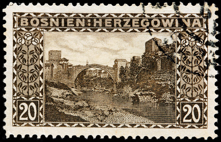BOSNIA AND HERZEGOVINA - CIRCA 1906: A stamp printed by BOSNIA AND HERZEGOVINA shows view of the famous Old Bridge in the city of Mostar that crosses the river Neretva, circa 1906のeditorial素材