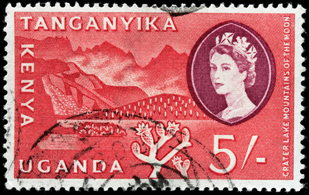 KENYA, TANGANYIKA, UGANDA - CIRCA 1960: A stamp printed by KENYA, TANGANYIKA, UGANDA (East African Community) shows view of Crater Lake and Mountains of the Moon, circa 1960のeditorial素材