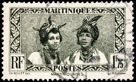 MARTINIQUE - AUGUST 10, 2015: A stamp printed by MARTINIQUE shows image portraits of two young Martinique women, circa May, 1933.のeditorial素材