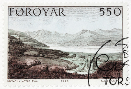 LUGA, RUSSIA - JUNE 26, 2016: A stamp printed by FAROE ISLANDS shows Faroese landscape.  Engraving after drawing by painting of famous English watercolour artist Edward Dayes, circa 1985.のeditorial素材