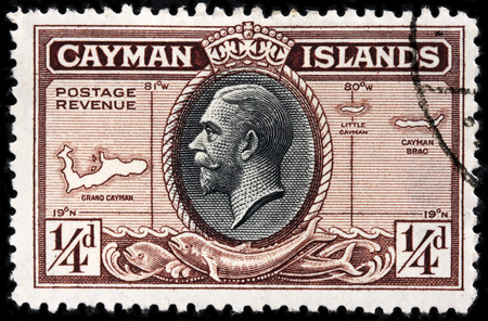 LUGA, RUSSIA - JUNE 25, 2016: A stamp printed by CAYMAN ISLANDS shows portrait of King George V against Cayman Islands map - British Overseas Territory in western Caribbean Sea, circa 1935のeditorial素材