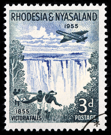 LUGA, RUSSIA - SEPTEMBER 18, 2015: A stamp printed by RHODESIA AND NYASALAND shows beautiful view of Victoria falls - a waterfall in southern Africa on the Zambezi River, circa 1955のeditorial素材