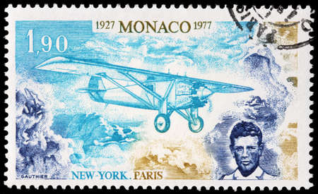 LUGA, RUSSIA - SEPTEMBER 02, 2019: A stamp printed by MONACO shows portrait of American aviator Charles Lindbergh and his single-engine monoplane, the Spirit of St. Louis, circa 1977.のeditorial素材