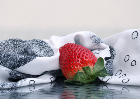 Still life with black and white napkin and sweet ripe strawberry. Selective and soft focus. Free space for your text.の写真素材