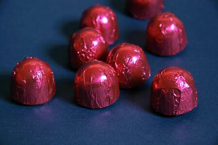 Chocolate drops on blue backgroundの写真素材