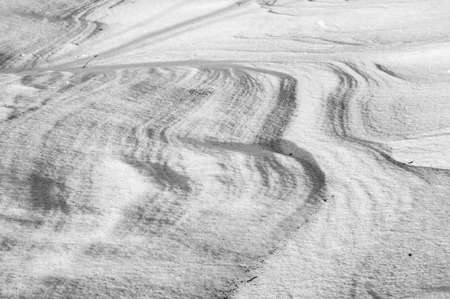 Sleet at a wind sticks to the ground, forming beautiful reliefsの写真素材