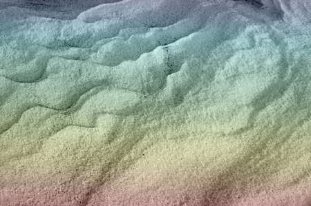 Sleet at a wind sticks to the ground, forming beautiful reliefsの写真素材