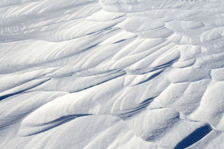 Sleet at a wind sticks to the ground, forming beautiful reliefsの写真素材