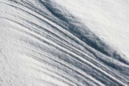 Sleet at a wind sticks to the ground, forming beautiful reliefsの写真素材