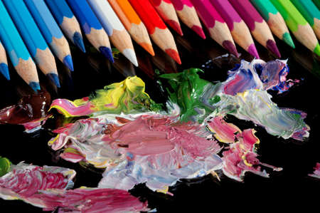 Mixing of an oil paint on black glass.の写真素材