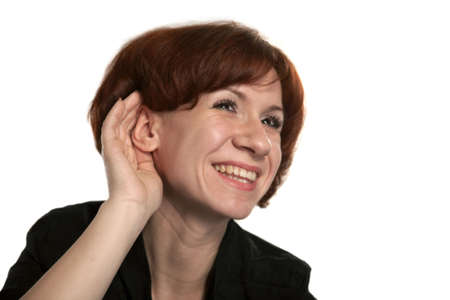 Curious girl attentively listens to far soundsの写真素材