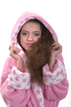 Girl in a pink long dressing gown on a white backgroundの写真素材