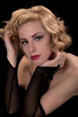 Blonde in a black dress in style of the beginning of 20 centuries