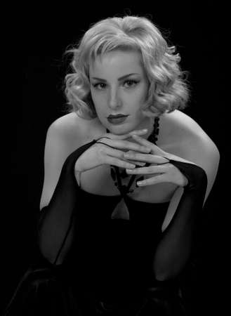 Blonde in a black dress in style of the beginning of 20 centuries