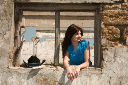 Cowgirl on a background of ruins of an old farm Cowgirl on a background of ruins of an old farm