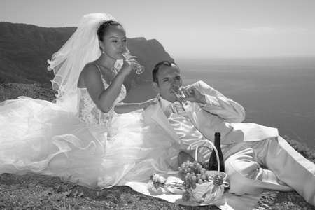 Newly-married couple have arranged picnic on high mountain の写真素材