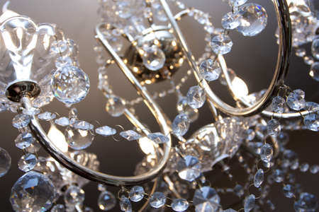 Crystal chandelier with the included bulbs against a wallの写真素材