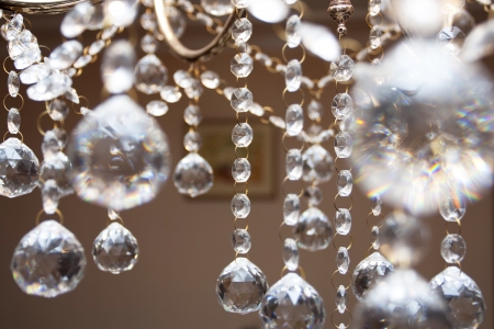 Crystal chandelier with the included bulbs against a wallの写真素材