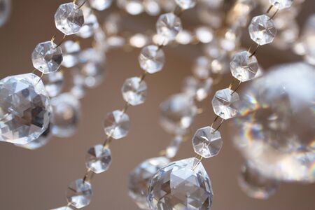 Crystal chandelier with the included bulbs against a wall