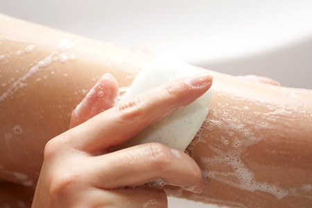 Washing of feet by soap in a bathroom with a skin