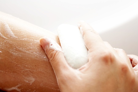 Washing of feet by soap in a bathroom with a skinの写真素材