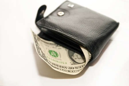 Black purse with dollar on a white backgroundの写真素材