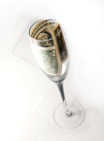 One dollar in a crystal glass on a white backgroundの写真素材