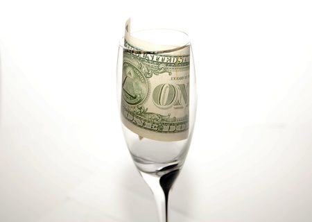 One dollar in a crystal glass on a white backgroundの写真素材
