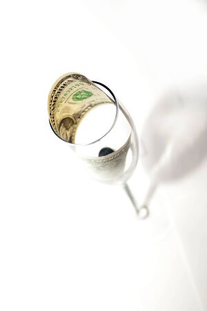 One dollar in a crystal glass on a white backgroundの写真素材