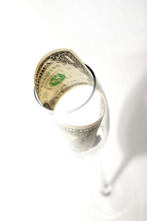 One dollar in a crystal glass on a white background