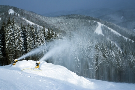 Snow creation on a hillside against snow routes