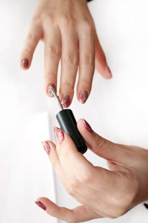 Process of plotting of a varnish on female nailsの写真素材