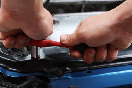Car repairs by the mechanic by means of the toolの写真素材