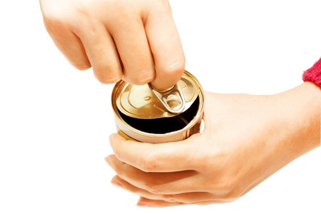 Process of opening of a can with tinned products on a white background