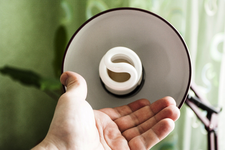 Process of replacement of an electric spiral lamp at officeの写真素材