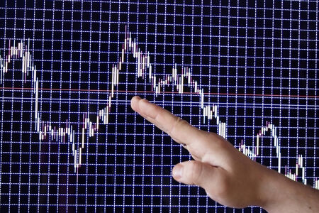 Demonstration of financial schedules by means of a hand on the monitorの写真素材