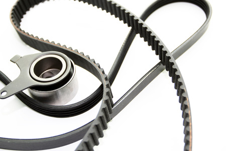 Rubber PV, gear belts and rollers for the car engine on a white background