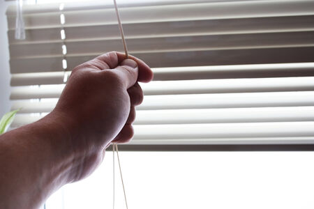 Bright sunlight when opening by a hand of curtains of blinds
