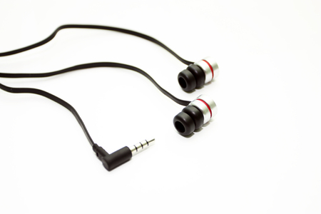 The most musical earphones to a player with a plug on a white backgroundの写真素材